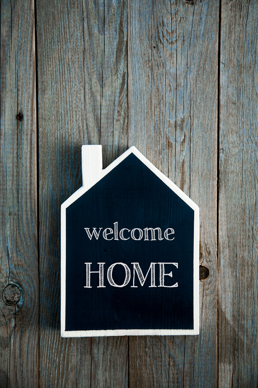 House Shaped Chalkboard sign on rustic wood WELCOME HOME